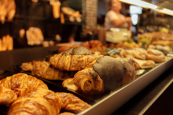 Selective focus of tasty croissants on bakery showcase in Catalonia, Spain 