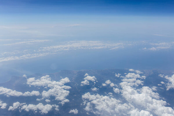 Aerial view of clouds above sea and coast of Catalonia, Spain 