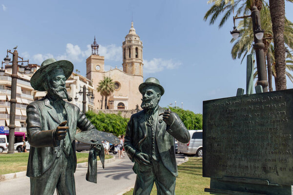 SITGES, SPAIN - APRIL 30, 2020 : Monument to Santiago Rusinol and Ramon Casas on urban street