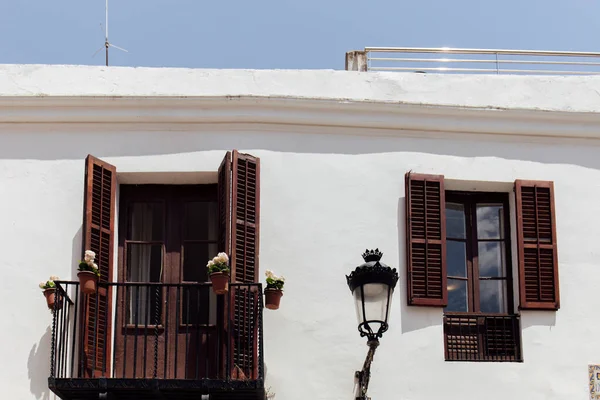 White facade of building with wooden shutters on window and balcony door in Catalonia, Spain — Stock Image White Facade Building Wooden Shutters Window Balcony Door Catalonia Spain Royalty Free Stock Photos