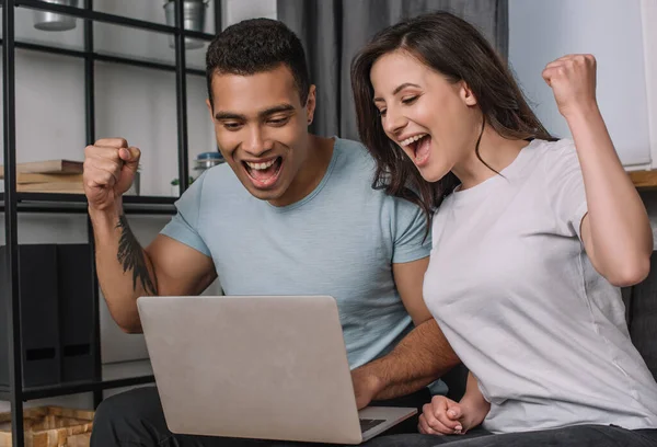 Cheerful Interracial Couple Celebrating While Looking Laptop — Stock Photo, Image