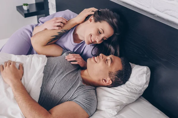 Tattooed Mixed Race Man Lying Touching Attractive Girl Bed — Stock Photo, Image