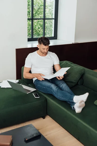 Selective Focus Man Holding Notebook Digital Devices Papers Couch — Stock Photo, Image
