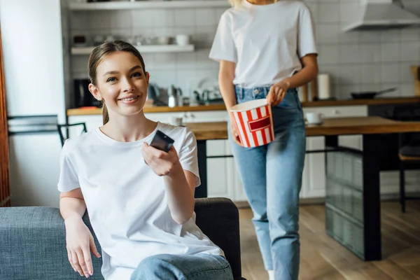 Selective Focus Happy Girl Holding Remote Controller Sister Tasty Popcorn — Stock Photo, Image