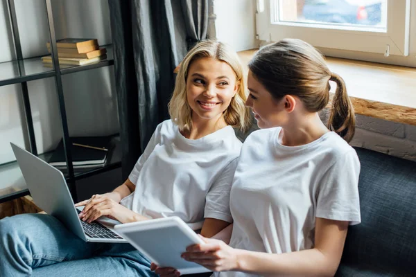 Selective Focus Sisters Smiling Each Other While Using Digital Tablet — Stock Photo, Image