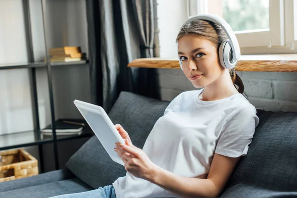 Attraktiv Kvinna Hörlurar Tittar Kameran När Använder Digital Tablett Soffan — Stockfoto