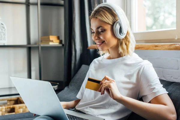 Kulaklıklı Güzel Bir Kadın Elinde Kredi Kartı Dizüstü Bilgisayar Var — Stok fotoğraf