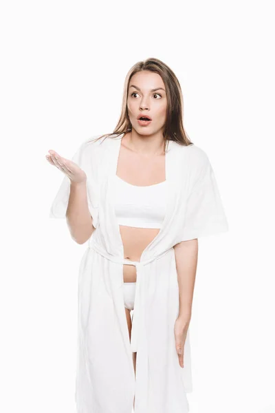 Woman in housecoat with shocked expression — Stock Photo