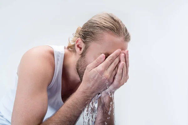 Young man washing face — Stock Photo