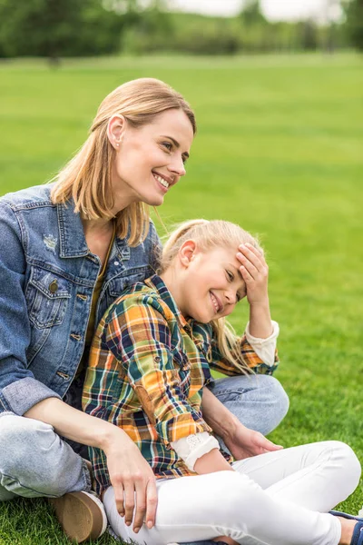 Family resting on lawn — Stock Photo