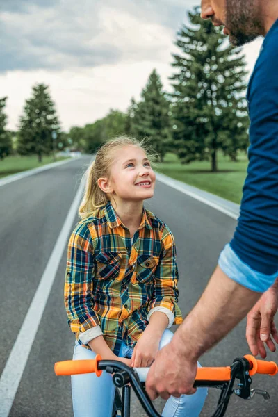 Girl sitting on bicycle — Stock Photo