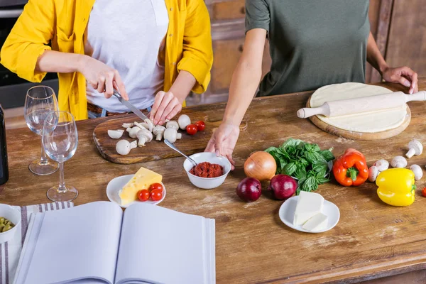 Women cooking pizza — Stock Photo