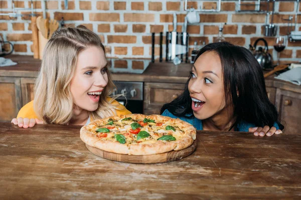 Multiethnic women with pizza — Stock Photo