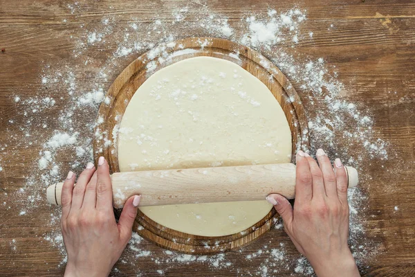Hands rolling dough — Stock Photo