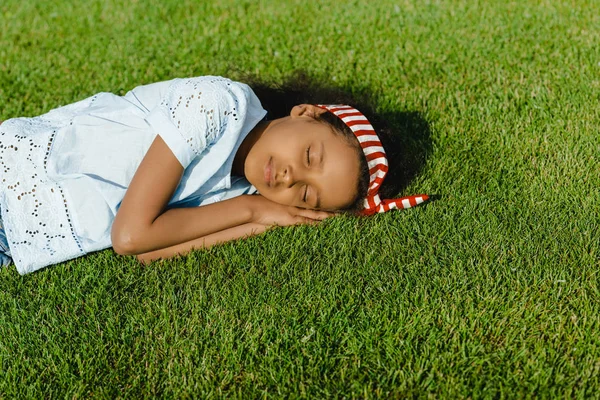 Africano menina americana dormindo na grama — Fotografia de Stock