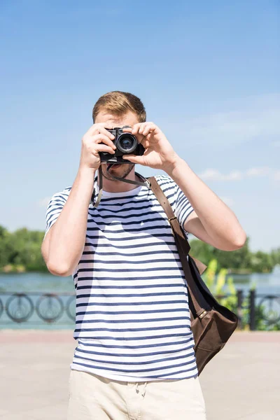 Young man with camera — Stock Photo