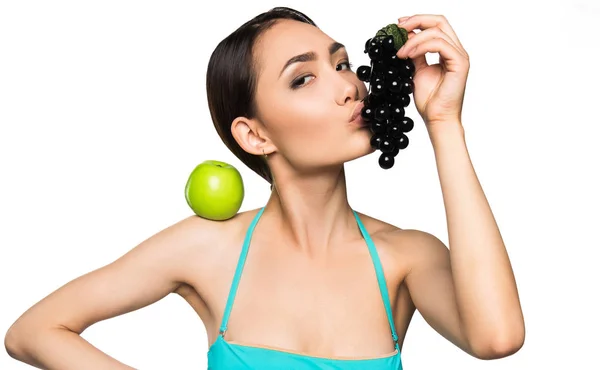 Woman with grapes and apple — Stock Photo