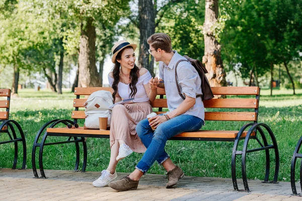 Multicultural couple sitting on bench — Stock Photo