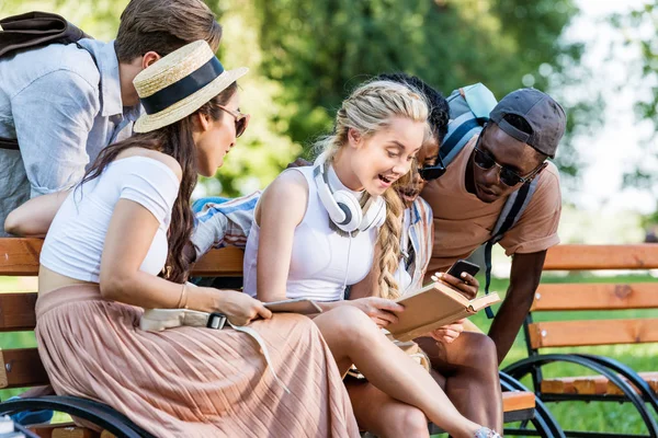 Multicultural students reading book — Stock Photo