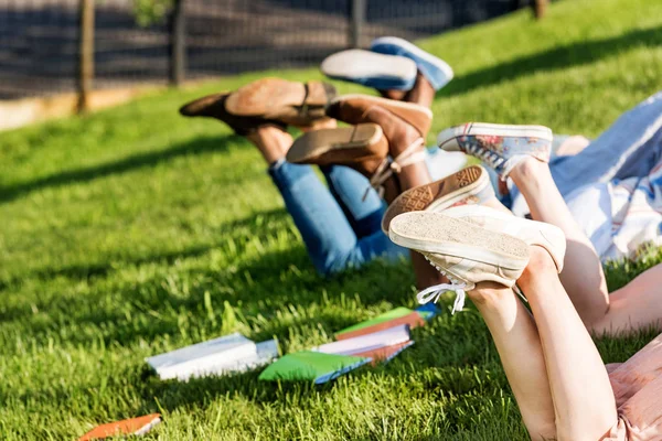 Students lying on grass — Stock Photo