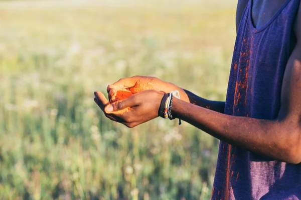 Man holding colorful dust — Stock Photo