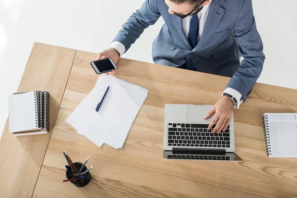 Businessman working on laptop at workplace — Stock Photo