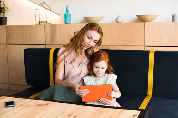 Mother and daughter with digital tablet — Stock Photo