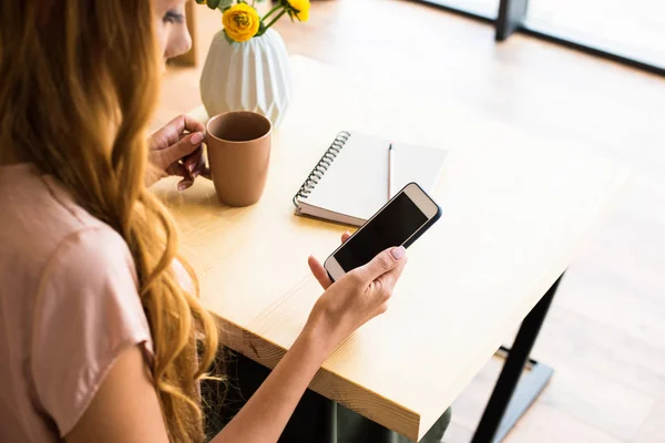 Mujer usando smartphone en la cafetería - foto de stock