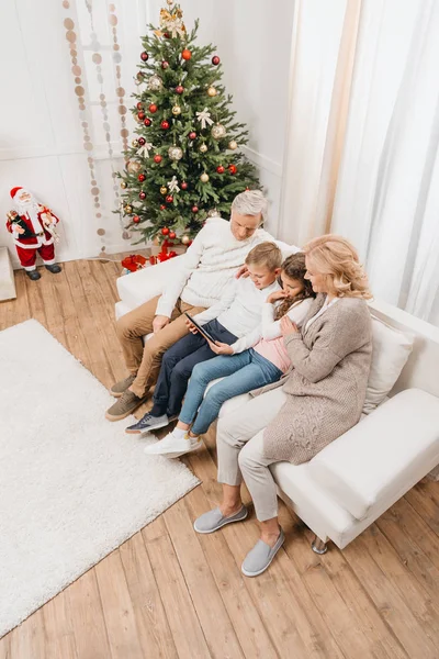 Grandparents and kids with tablet — Stock Photo