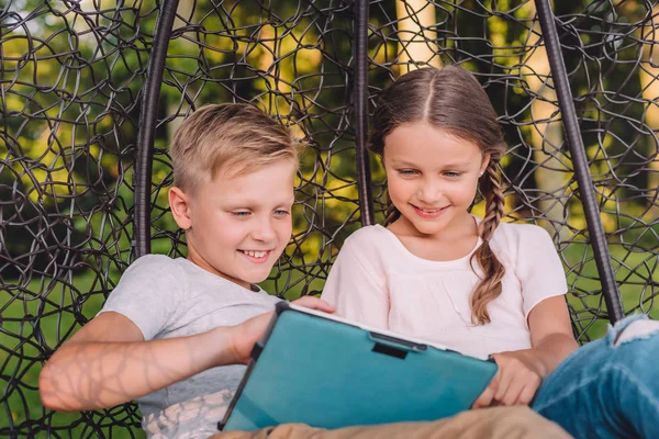Siblings with tablet — Stock Photo