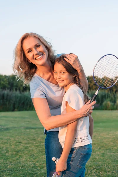 Smiling grandmother hugging granddaughter — Stock Photo