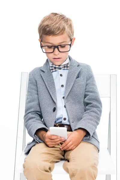 Focused schoolboy using smartphone — Stock Photo