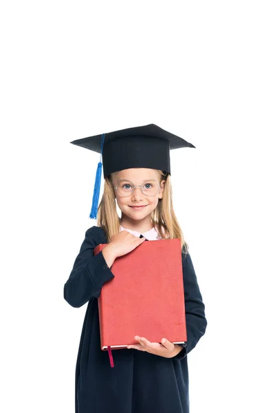 Schoolgirl in graduation hat with big book — Stock Photo