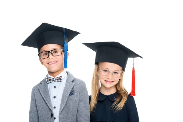 Pupils in graduation hats — Stock Photo