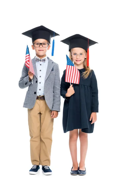 Pupils in graduation hats with usa flags — Stock Photo