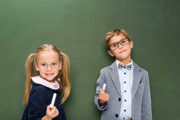 Pupils next to blackboard — Stock Photo