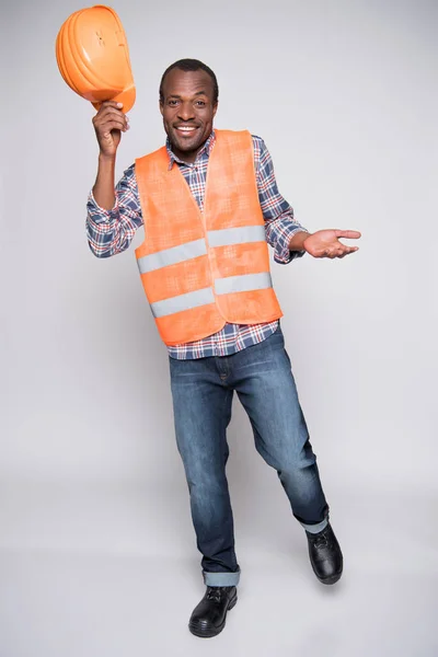 Construction worker raising hardhat — Stock Photo