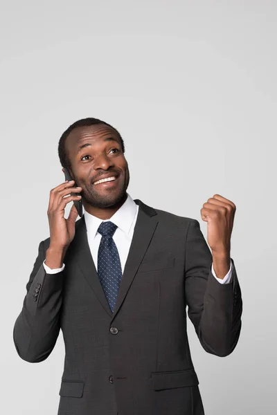 Cheering businessman talking on phone — Stock Photo
