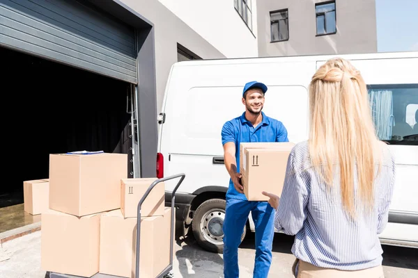 Courier giving package to woman — Stock Photo