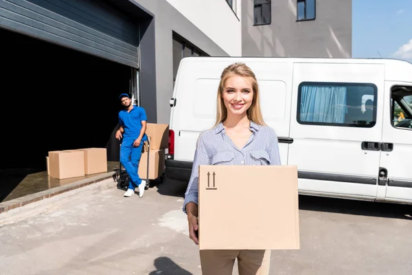 Woman with delivered package — Stock Photo