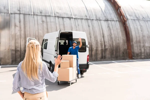 Courier delivering packages for woman — Stock Photo