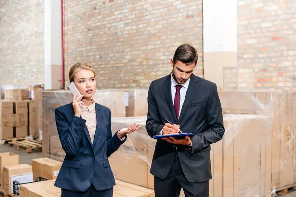 Business colleagues at warehouse — Stock Photo