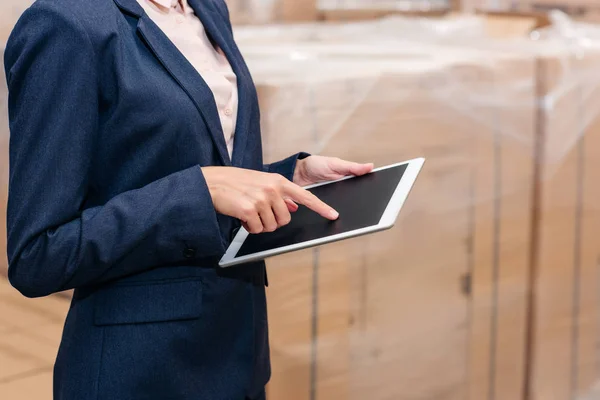 Businesswoman pointing at tablet — Stock Photo