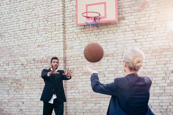 Business colleagues playing basketball — Stock Photo