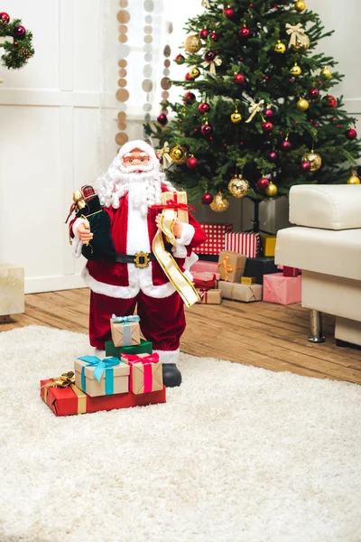 Decorative santa with christmas gifts — Stock Photo