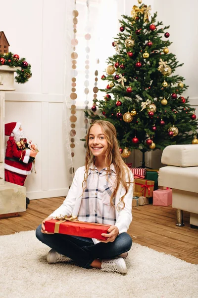 Teenager with christmas present — Stock Photo