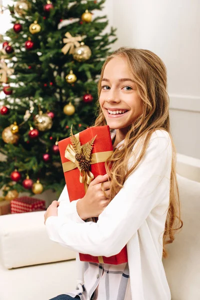 Teenager with christmas present — Stock Photo