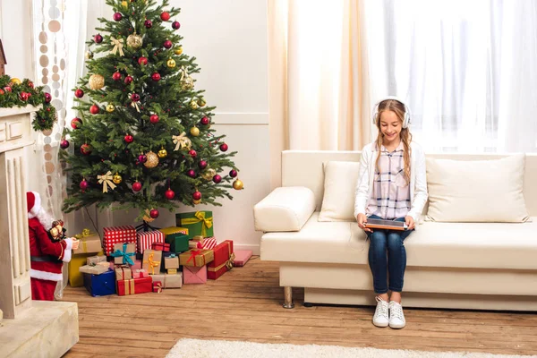 Adolescente con tableta digital en Navidad - foto de stock