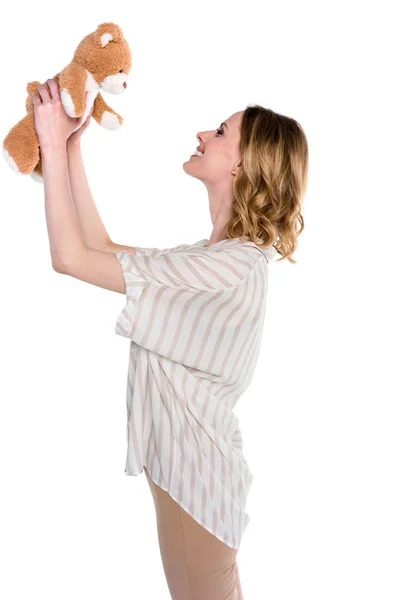 Woman holding up teddy bear — Stock Photo