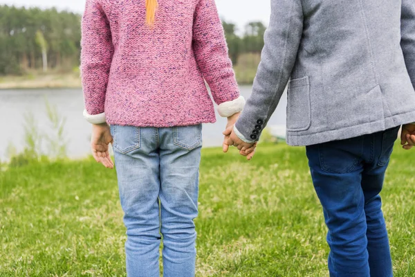 Siblings holding hands — Stock Photo